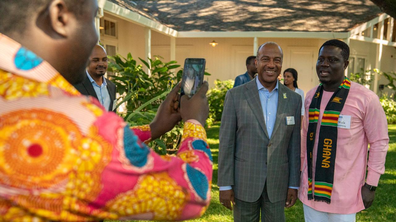 Chancellor Gary S. May poses for a photo with Mandela Fellows in 2019.