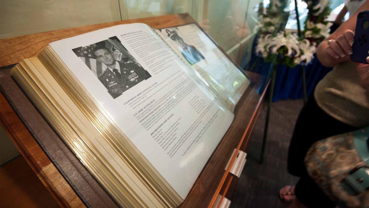 Book open to page showing Mark Taylor's biography