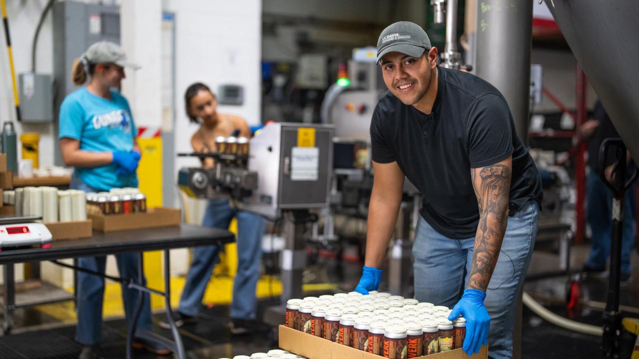 Student helps with beer packaging