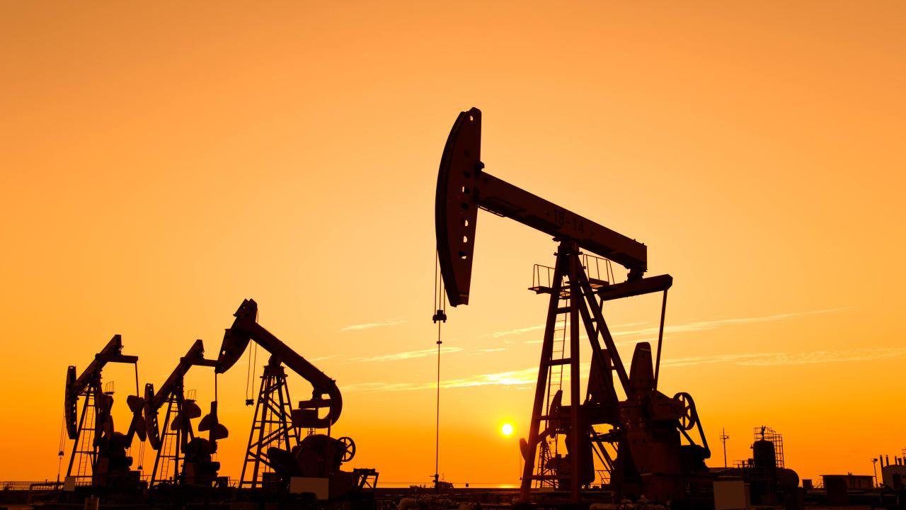 Oil wells in sunset.