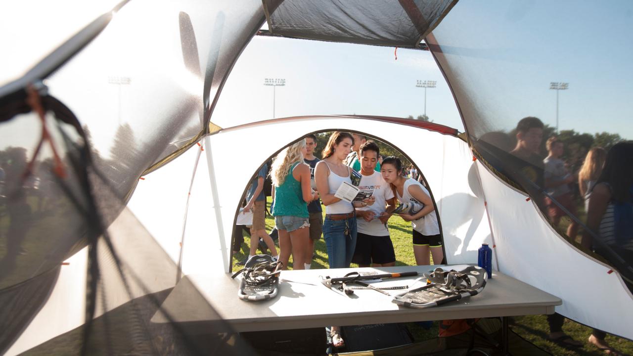 Looking out upon students near the opening of a camping tent