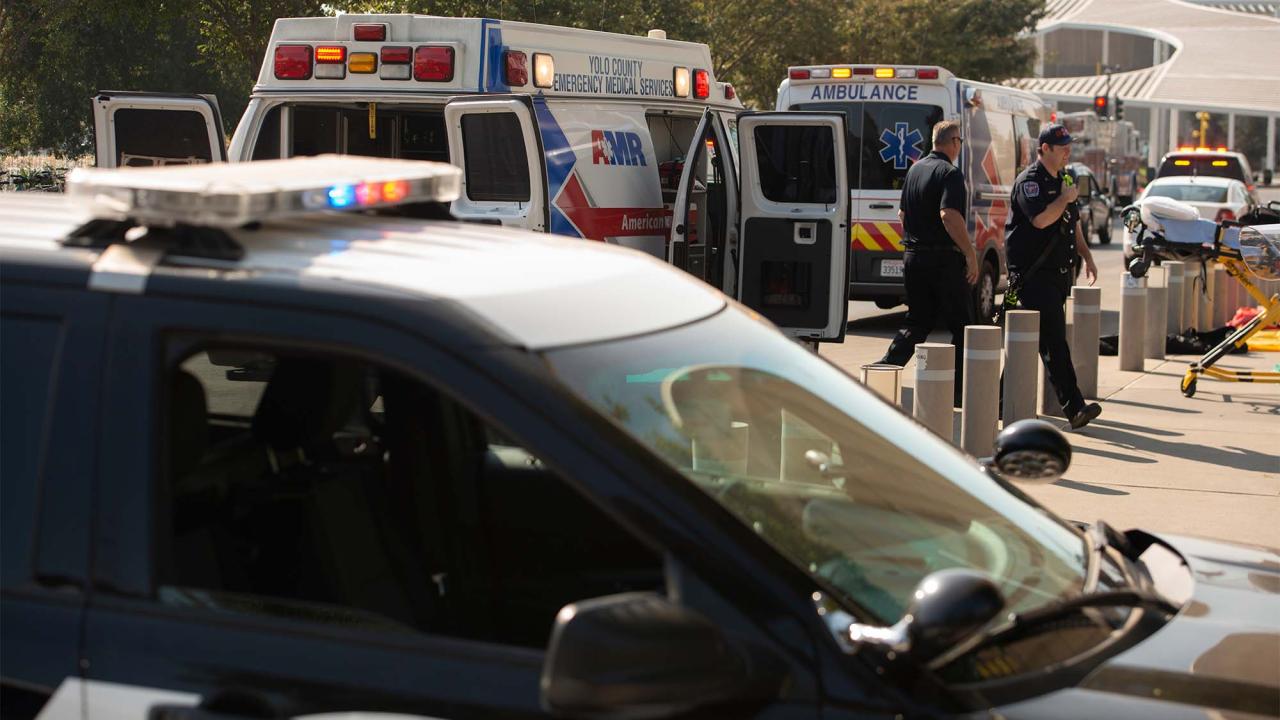 Firefighters and police move between ambulances outside the Mondavi Center during a training exercise.