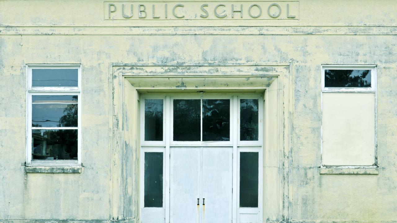 Front of public school with label above doors.