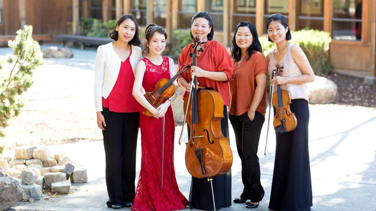 Group of performers wearing red