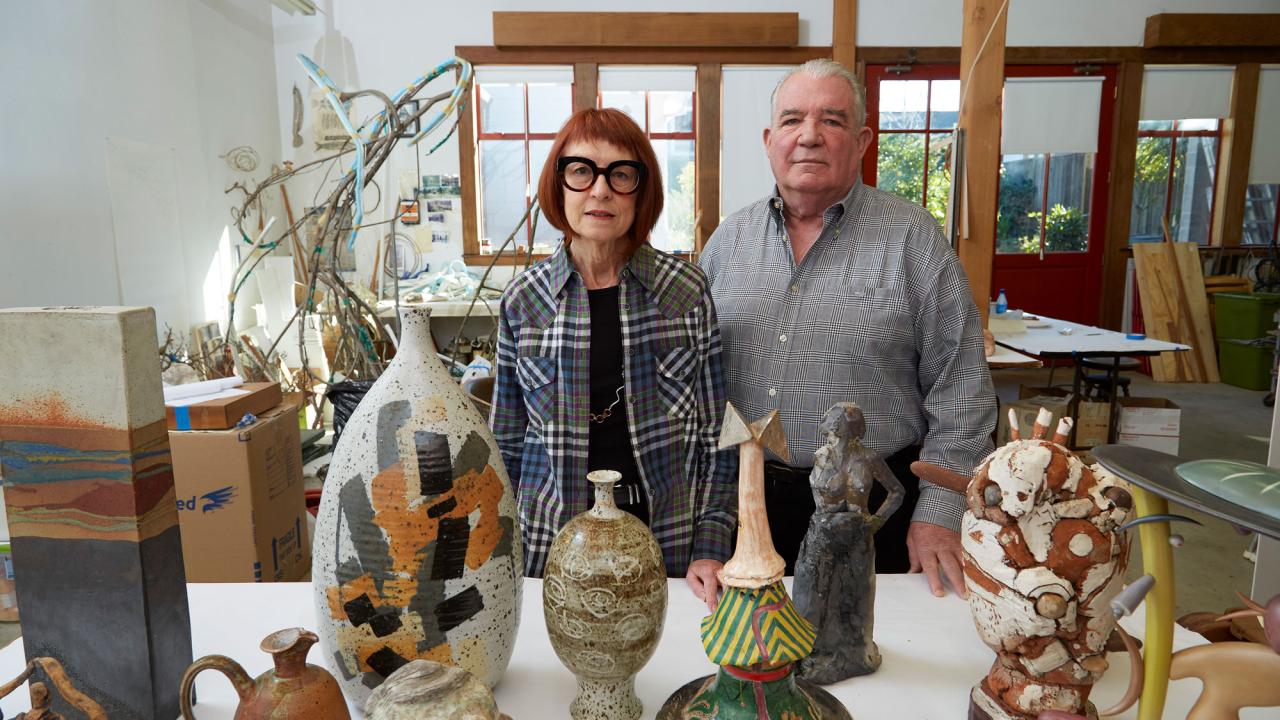 Couple in studio with colorful art pieces