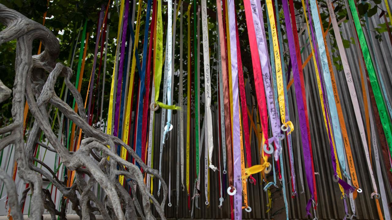 Streamers descending from trees next to sculpture in Manetti Shrem Museum of Art courtyard