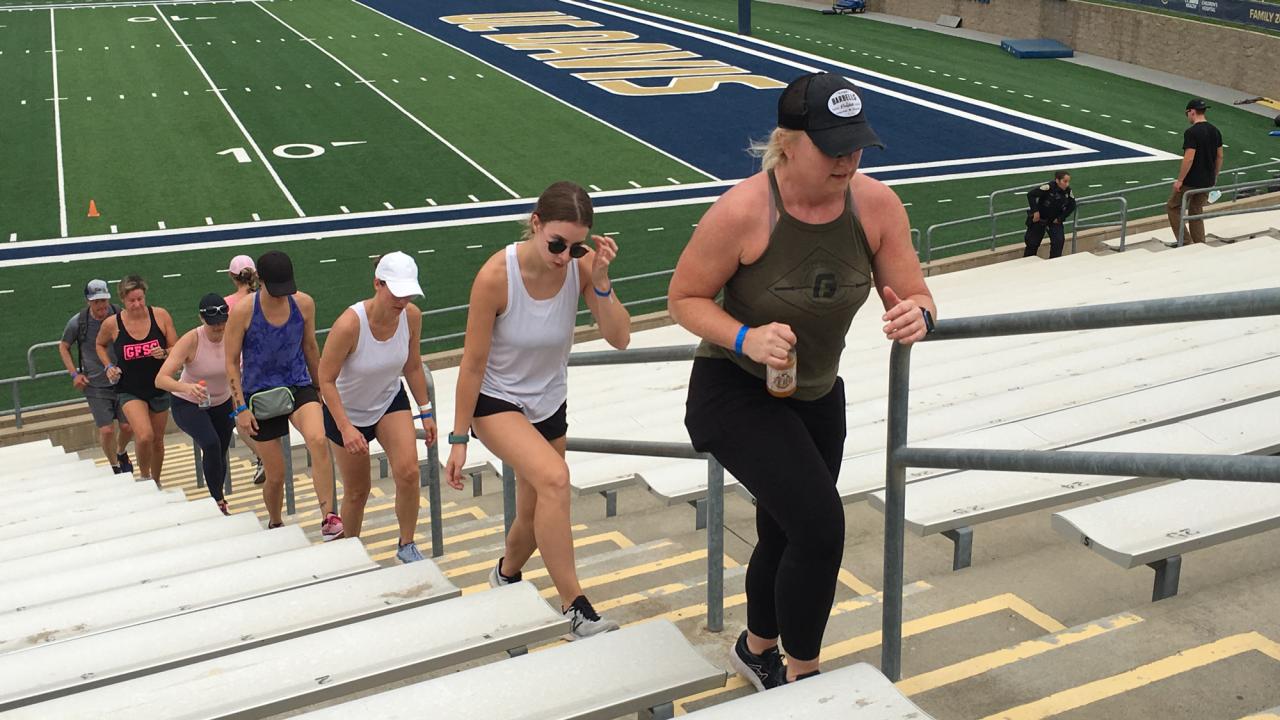 People walk up stairs football stadium