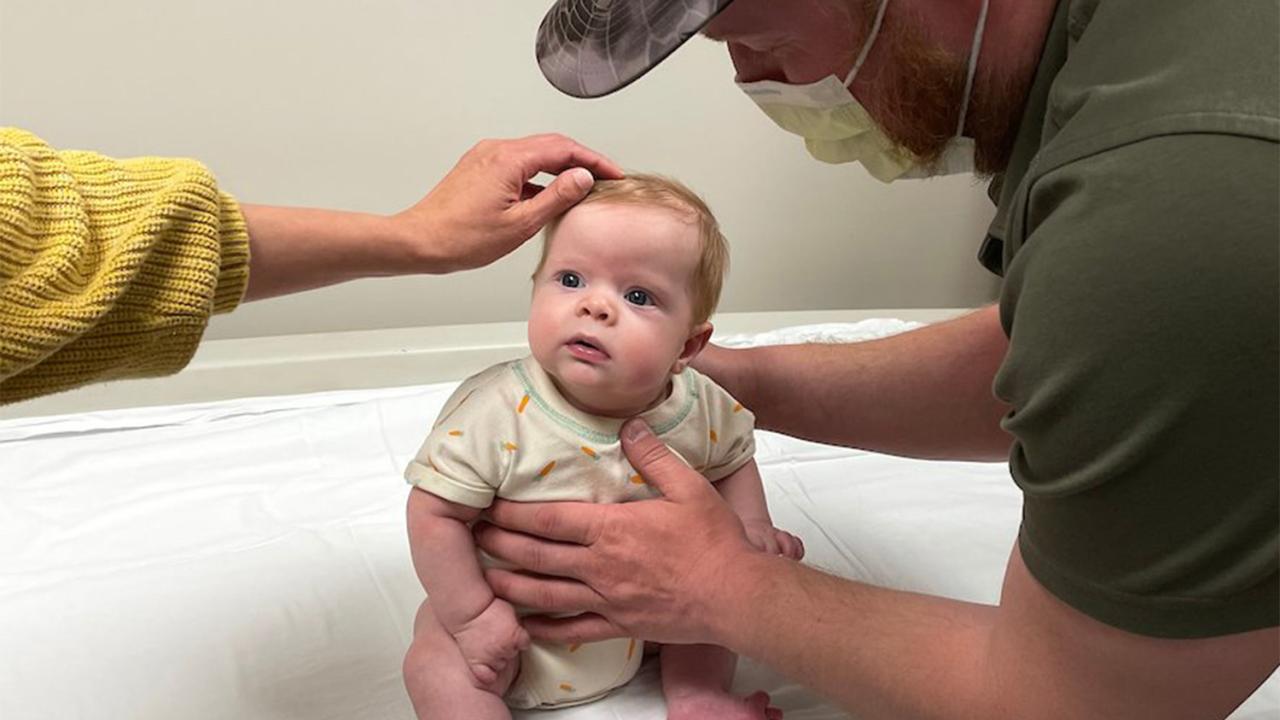 Baby sitting on examination table