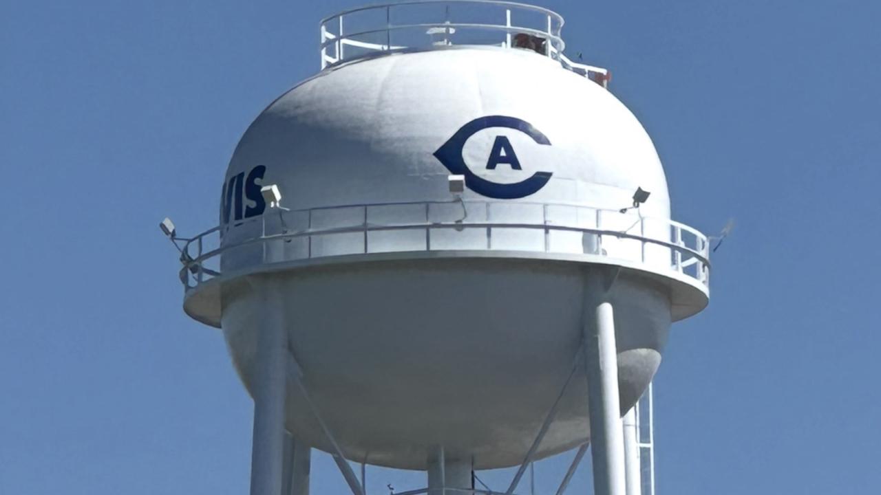Closeup of newly restored water tower on campus shows Athletics logo