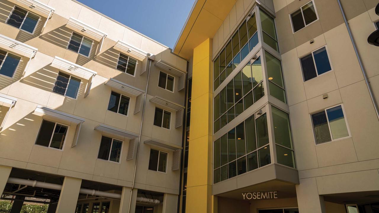 Exterior photo of a 4-story residence hall entrance courtyard