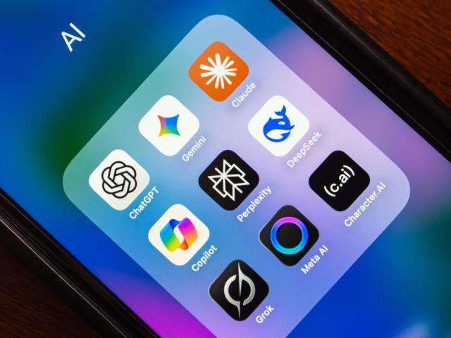 Phone screen with open app folder of colorful icons on gradient wallpaper