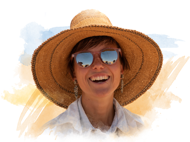 Young woman smiling with a sun hat on