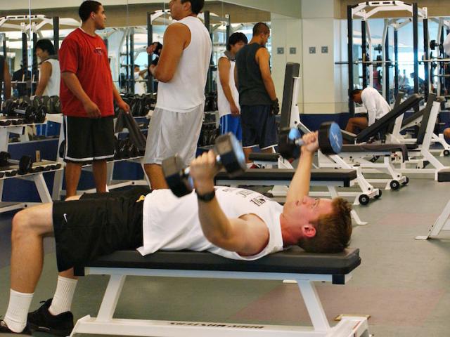 A male student works out in the UC Davis Activities and Recreation center weight room