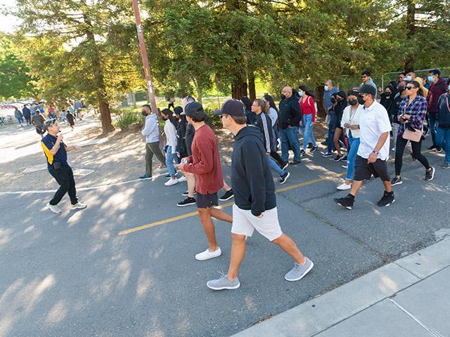 A student leading a group on a tour of campus