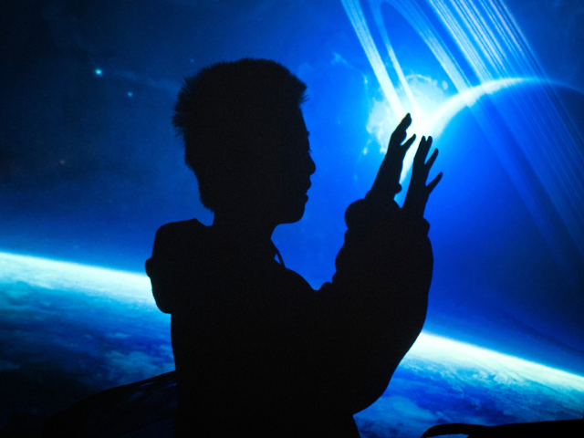 A youngter interacts with an artistic space display