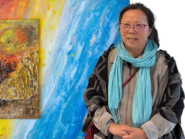 Artist is pictured in front of one of her paintings