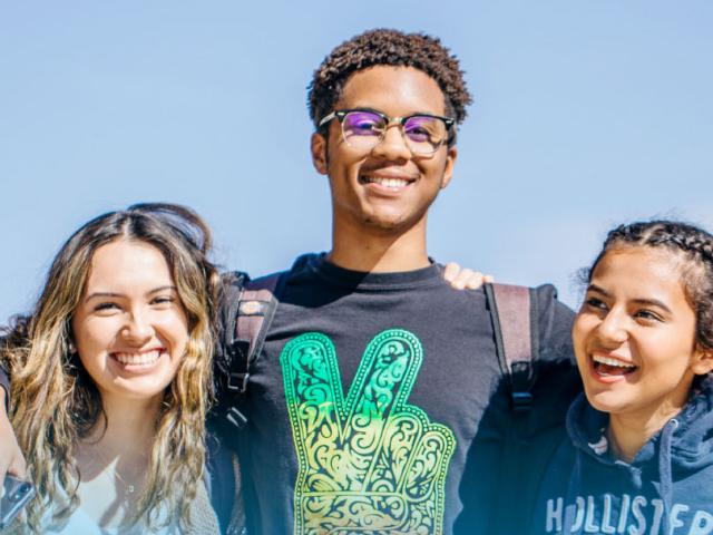 A group of UC students arm in arm