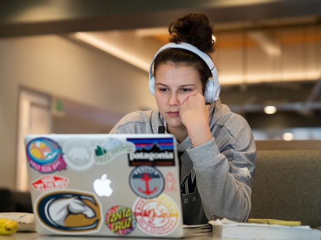 student looking at laptop computer 