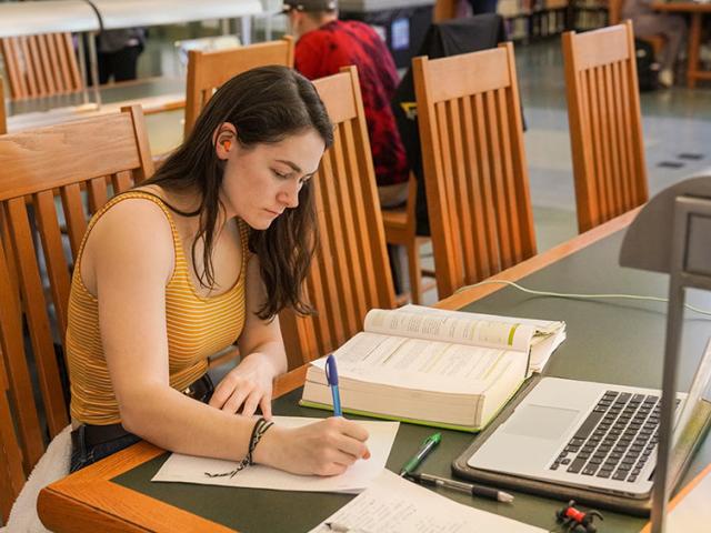student studies in the library