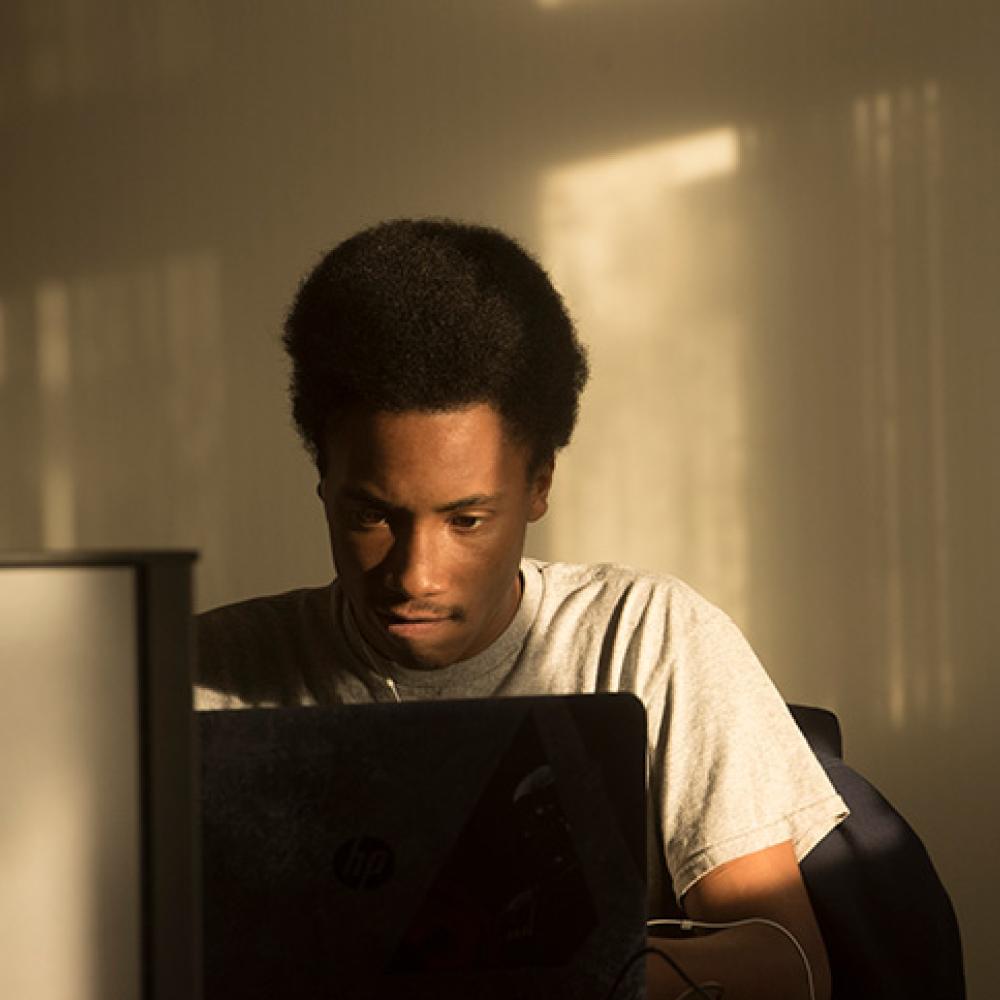 Male student studying in a room