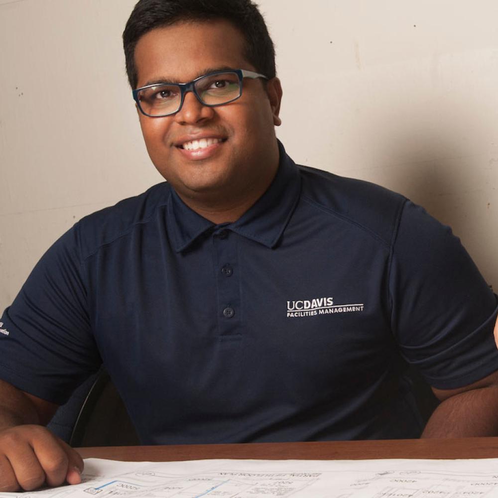 A student smiles over a city planning map