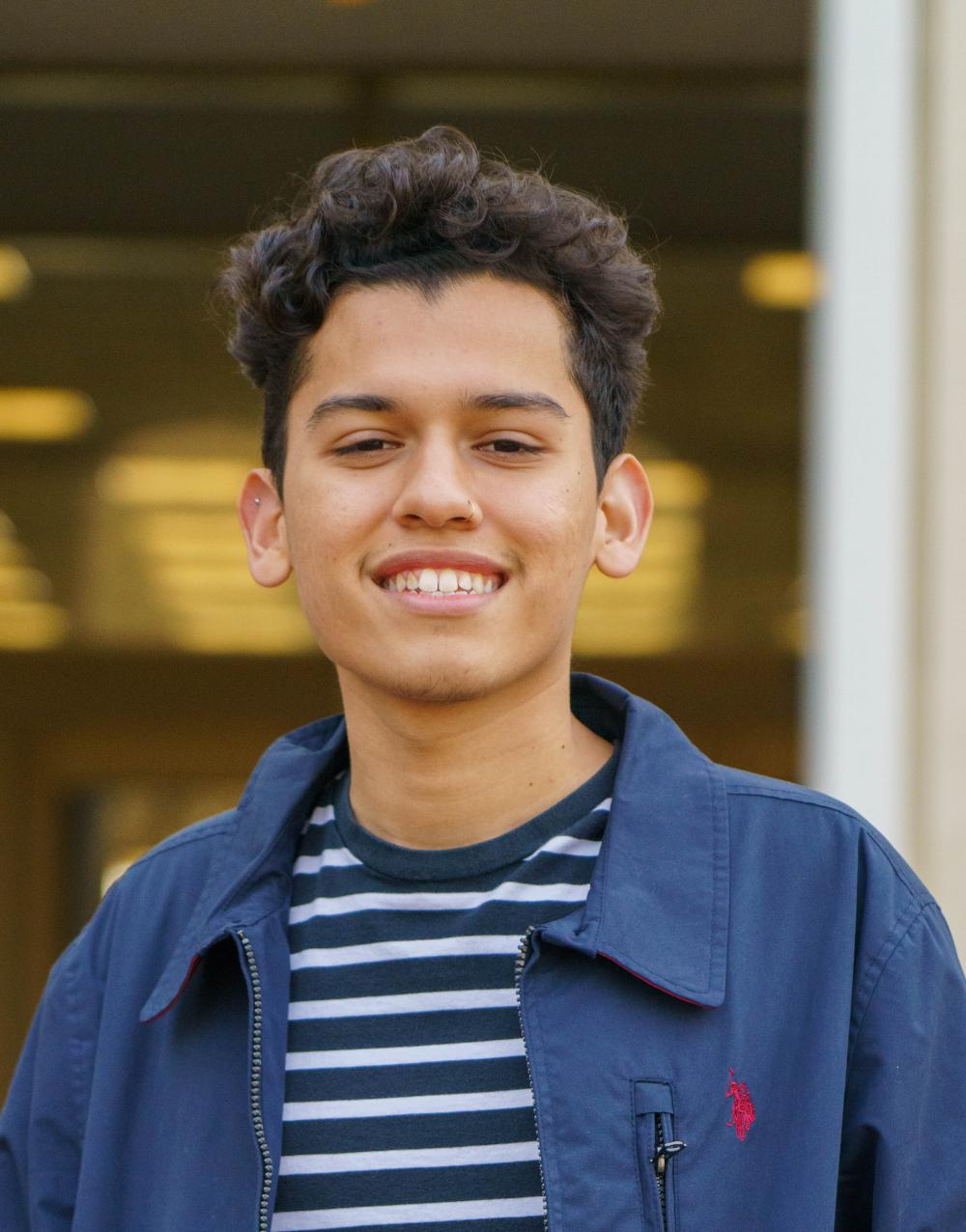 Emmanuel Fonseca smiling in front of UC Davis's Mrak Hall