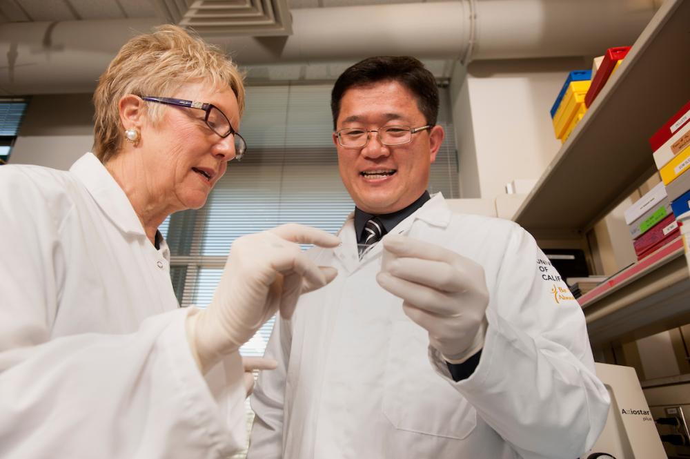 Two scientists in white lab coats. 