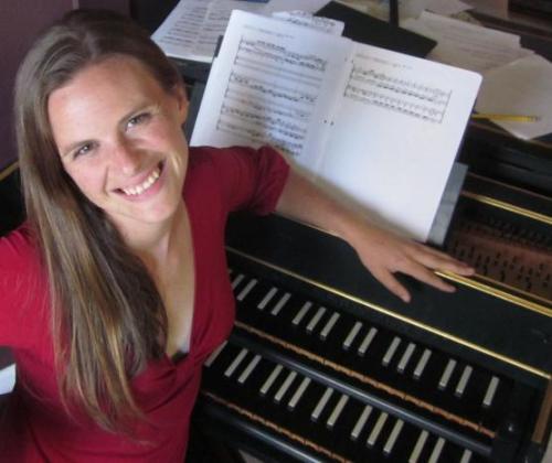 Woman looking up from musical instrument at UC Davis concert