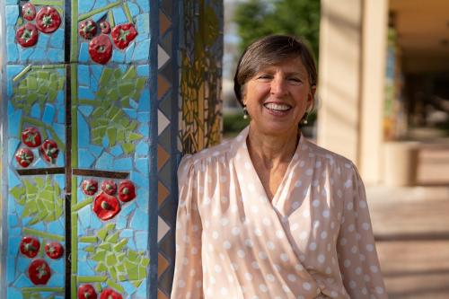 Woman by flowered backdrop