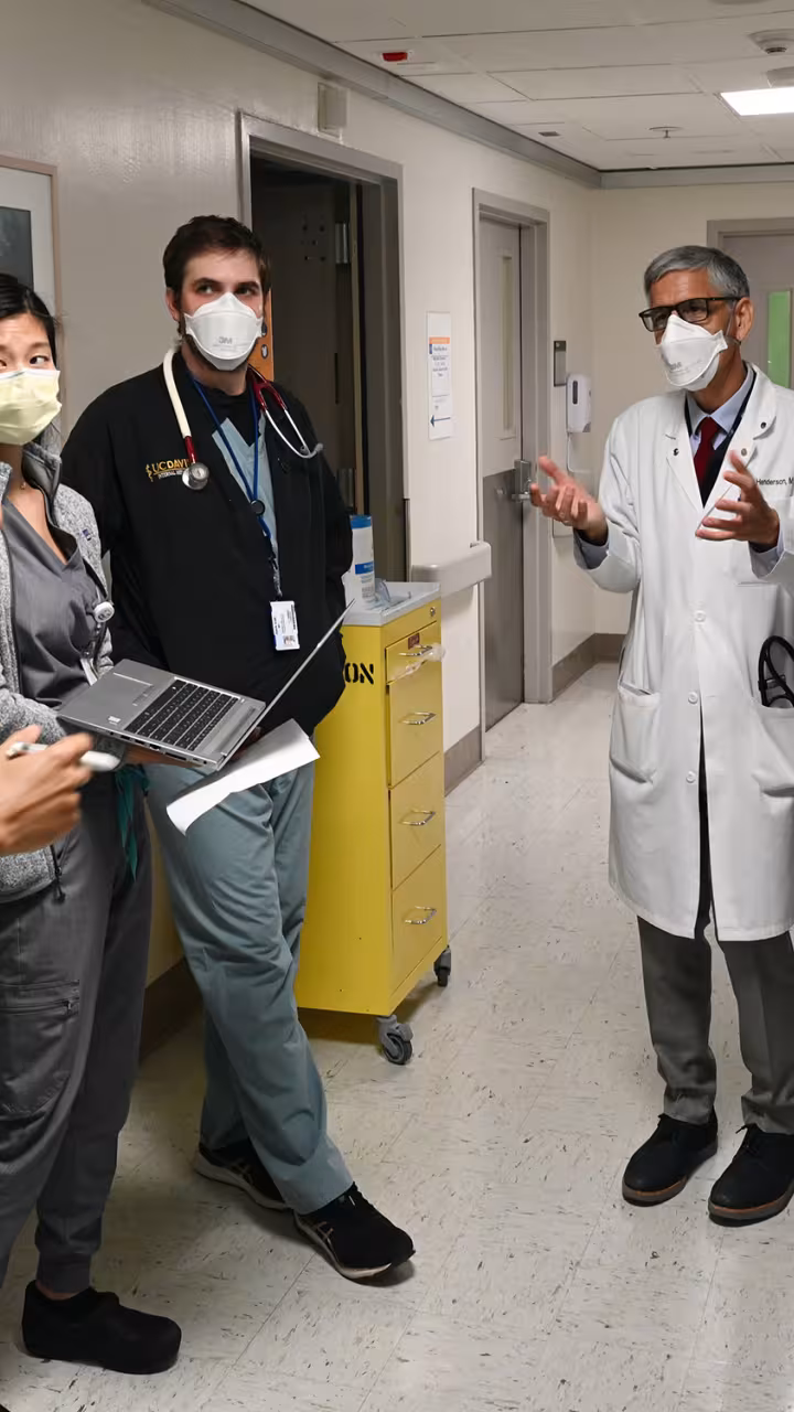Doctor in a white coat talks with medical students in a hospital