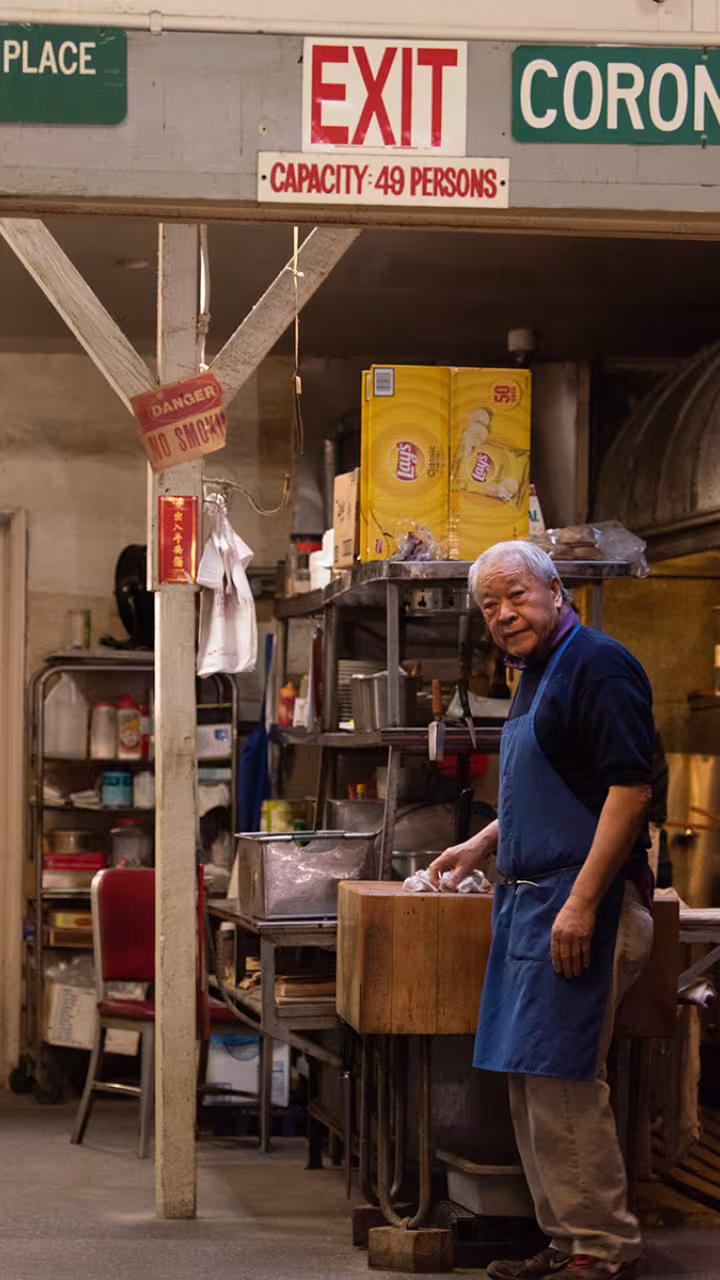 Man stands in the back of a historic restaurant