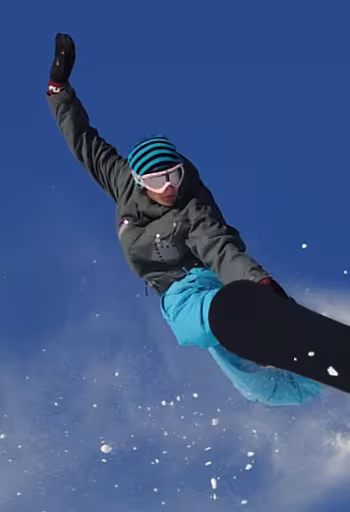 A snowboarder sends it off a sierra slope