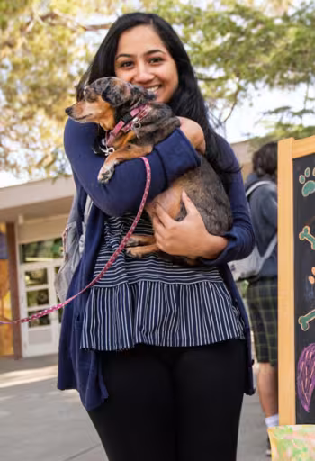 A student holds a puppy at the UCD memorial union