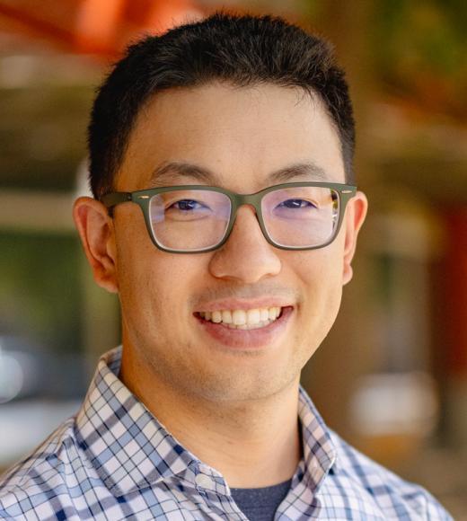 Transportation expert Alan Jenn wearing glasses and smiling in head shot