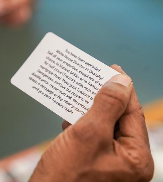 A hand holds a game card