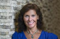 Woman in blue blouse against wall background at UC Davis