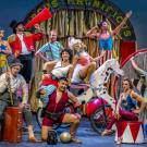 Members of the Cirque Mechanics troupe posing on stage in costume.