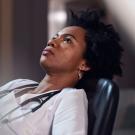 Doctor leans back in chair, reflecting.