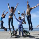 The Havana Cuba All-Star dancers jumpng in mid-air.