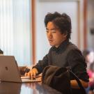 A student sits on his laptop at the Silo at UC Davis. 