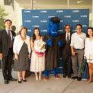 Gunrock stands with students during the 2018 International Student Graduation Celebration.