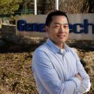 Mike Chan standing in front of sign