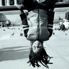 Child hangs upside down from outdoor play equipment, cropped from book cover.