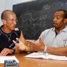 Biochemistry and molecular biology major Chris Jones, right, tutors Brandon Rice in chemistry