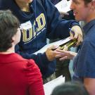 Career fair company representative talks to two students