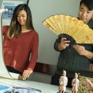 Senior communication major Karice Hui, left, and senior economics major Yongcong Cen view Asian art and cultural items