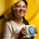 Woman holding a mechanism with a dial with eye glasses in the foreground