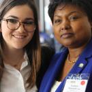 A student participant poses for a photo with Madame Mathilde Mukantabana, Ambassador of the Republic of Rwanda to the US