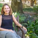 Plant scientist Siobhan Brady sitting on a bench with plants.