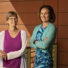 Two professors in front of a wall